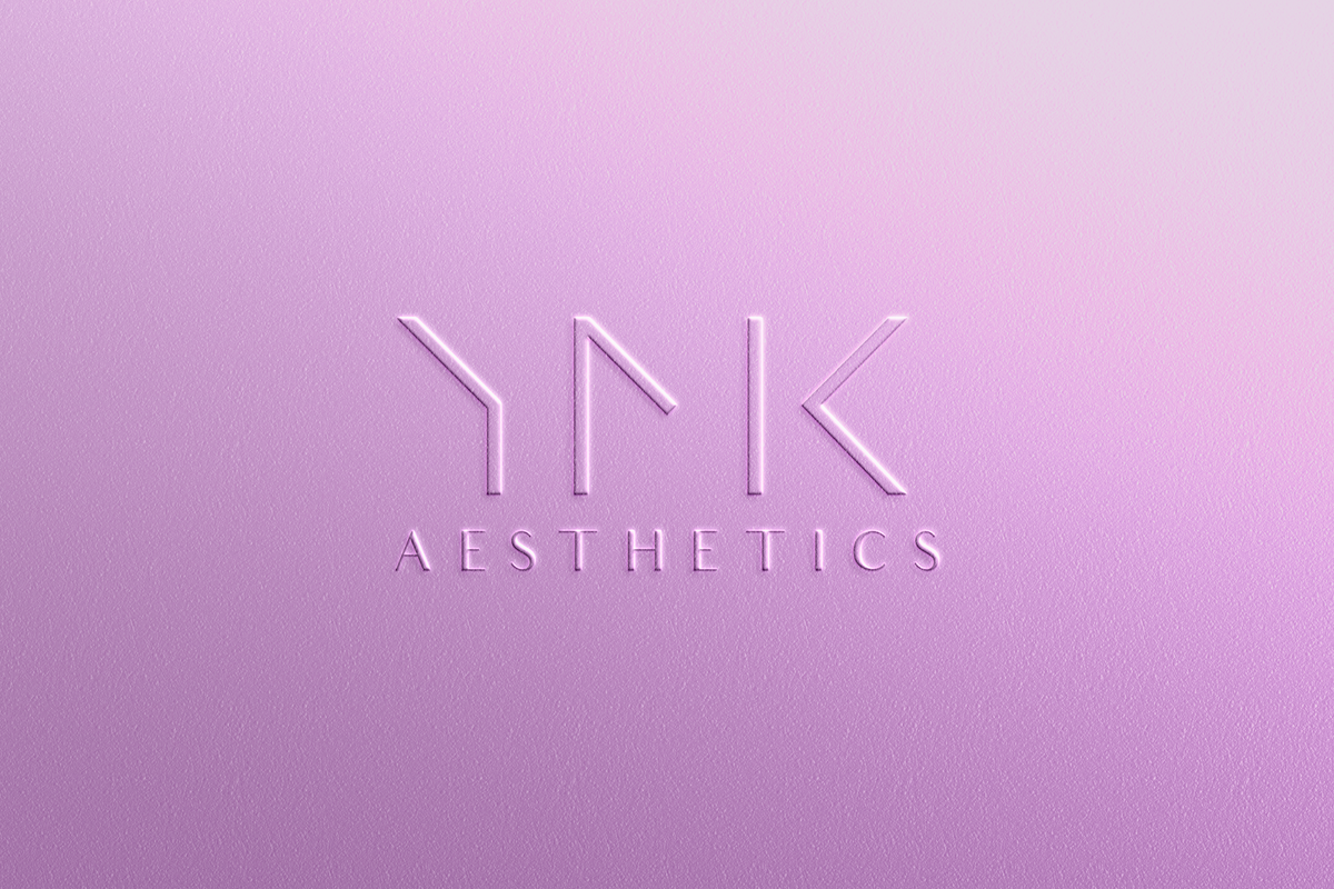 YNK Aesthetics logo on a light purple background