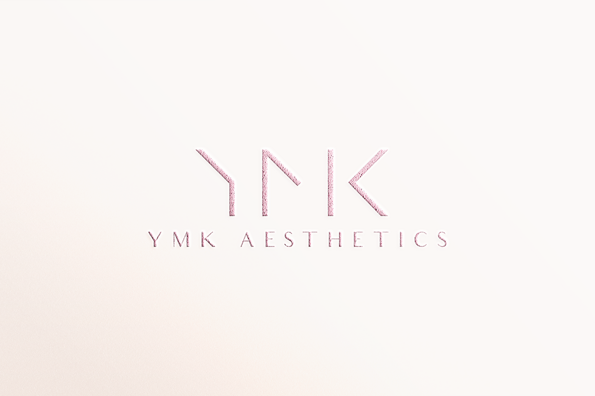 YMK Aesthetics logo on a light pink background