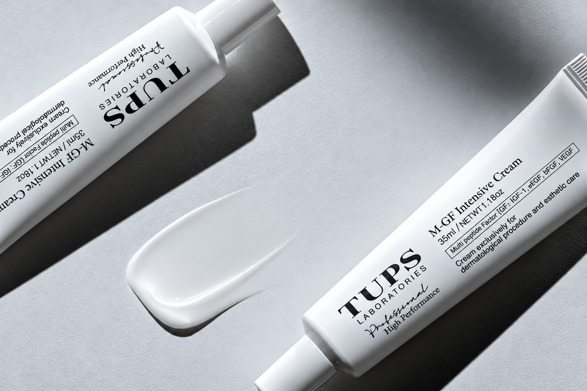 Two white TUPS M-GF Intensive Cream tubes arranged diagonally beside a cream swatch on a light gray surface with pronounced shadows.