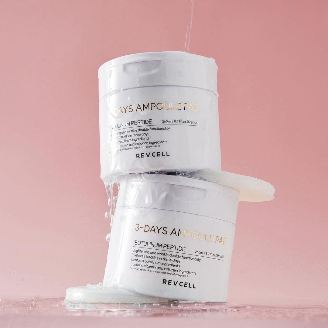 Two white containers labeled '3-Days Ampoule Pad' with REVCELL branding on a pink background.